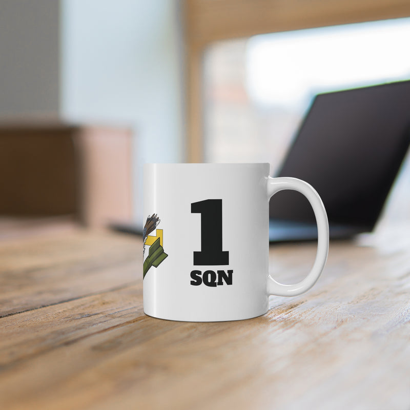 White mug with '1 Sqn' text on a wooden surface