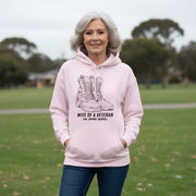 Australian Warfighters Coffee pale pink cotton-poly blend hoodie with a graphic of combat boots and text "Wife of a Veteran — Love. Support. Sacrifice."